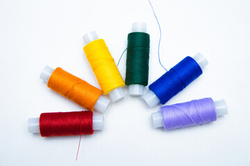 Skeins with threads are lined up in a row according to the color of the rainbow. top view, flat lay, copy space, isolate High quality photo