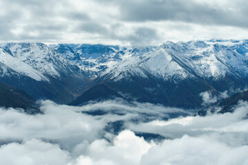 Aerial view above the clouds in mountain valley at morning