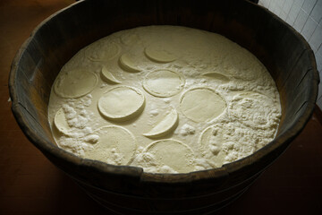 wooden tub with cheese in the artisan dairy