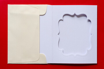 plain die cut paper card with fancy window opening inside an envelope