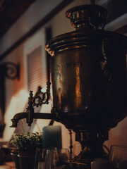 Fototapeta na wymiar A closeup shot of antique copper samovar in a beautiful interior setting