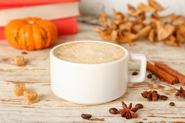 Tasty cup of coffee on white wooden background