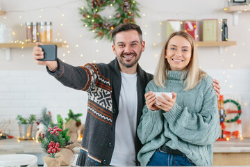 Couple in love husband and wife talk together on video call with friends and family, young family happily celebrates Christmas and New Year breath at home