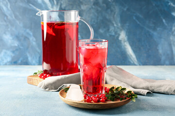 Glass of cold lingonberry tea on table
