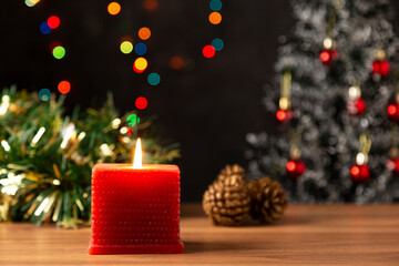Candle lights on a table decorated for Christmas.