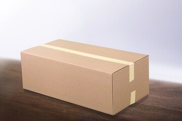 Brown cardboard box with tape. Suitable for packaging.