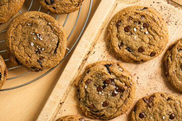 Organic food snack tasty sweet dessert milk dark chocolate chip salt cookie closeup piece fruit orange raspberry hazelnut nuts cinnamon on cocoa cacao powder wooden table for new year Christmas gift