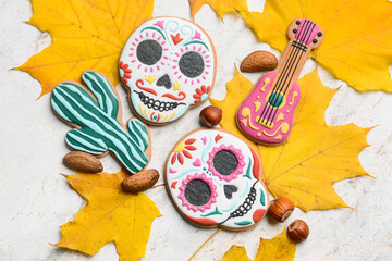 Tasty cookies for Mexico's Day of the Dead (El Dia de Muertos) with nuts and fallen leaves on white background