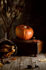 Pumpkins and vintage jewelry box on wooden table