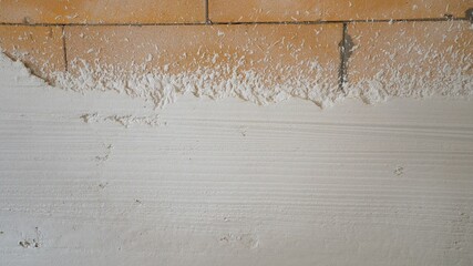 Machine application of plaster to the wall. Plasterer throws plaster on the wall. Plastering walls...
