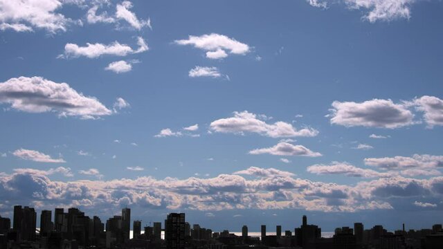 City Skyline with blue sky and white clouds in a time lapse sequence