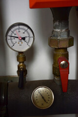 Gas boiler pressure gauges with iron pipes emanating from them and pressure switches