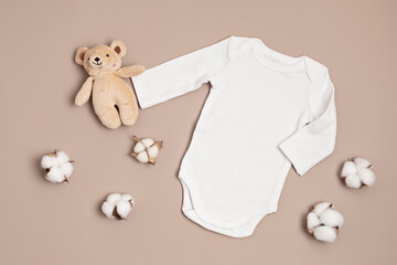 Mockup of white infant bodysuit made of organic cotton with eco friendly baby toys. Onesie template...