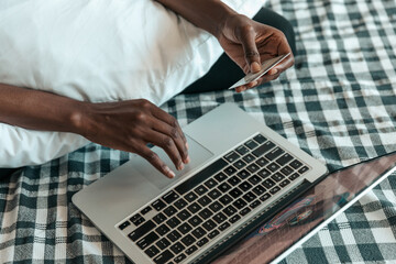 Fototapeta na wymiar Black woman typing on a laptop
