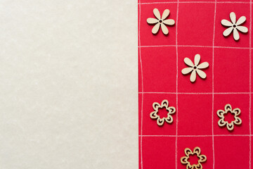 laser cut wooden flower shapes arranged on red paper with hand drawn grid