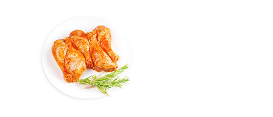 Baner.Cooking chicken drumsticks.Raw chicken legs in a marinade with rosemary on a background.Top view, copy space.Isolated.Marinated chicken dramstick with spices for cooking.