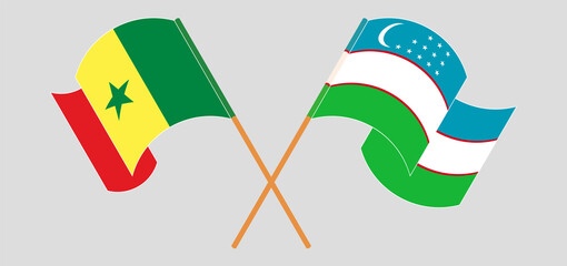 Crossed and waving flags of Senegal and Uzbekistan