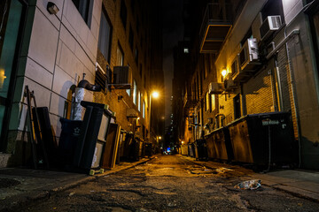 Fototapeta na wymiar dark alleyway between buildings in major city