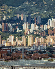 beautiful shot of city in the hills with mountain landscape in background