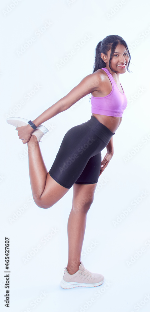 Wall mural Pretty woman with sportswear on a white background