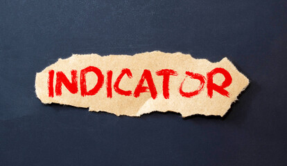 INDICATOR - word on a notebook on a light wooden background with a calculator and a pen.