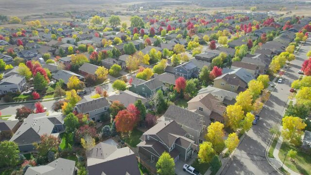 Dynamic aerial drone view of suburban housing development in United States