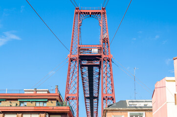 Fototapeta premium Colorful facades in Portugalete old town, with the famous Vizcaya Bridge in the background