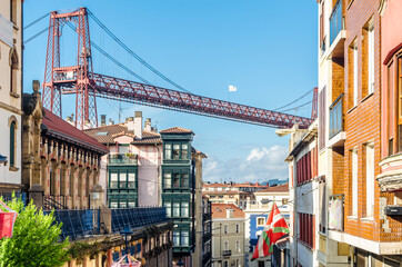Fototapeta na wymiar Colorful facades in Portugalete old town, with the famous Vizcaya Bridge in the background