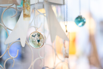 Necklaces hanging surrounded by colors and light