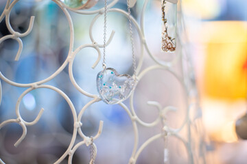 Necklaces hanging surrounded by colors and light