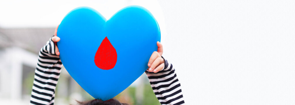 Light blue heart on kid hand with blood banner background.World diabetes day.Diabetes on kid.Heart danger insulin.Family support for child.blood cells donation world.World Aids day.November Diabetes. - Powered by Adobe
