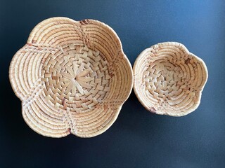 Handmade flower shape basket made from dried water hyacinth, woven basket for home use and decoration, weaved basket on black background
