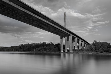 Naklejka premium A wide angle, black and white, long exposure shot of the William V. Roth Bridge in Delaware