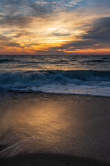Fototapeta na wymiar A stormy sunrise as seen from the beach at False Cape State Park