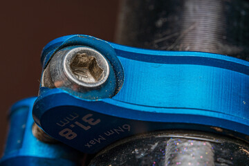 Bicycle seatpost clamp. CNC machined part made of blue anodized aluminium.