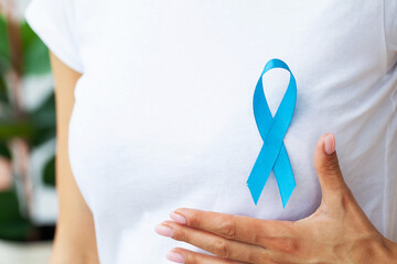 Woman with blue ribbon, prostate cancer awareness