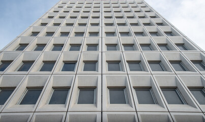 View of facade of large building with geometric pattern exterior. Shot of geometric abstract pattern background.