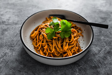 vegan red pesto fettuccini with parsley topping, healthy plant-based food