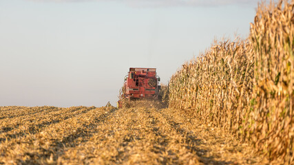 combine harvester working on a field in a french coutryside