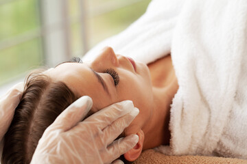 Obraz na płótnie Canvas Young woman getting spa massage treatment at beauty spa salon