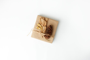 Eco-friendly Christmas decor: gift boxes Packed in brown Kraft paper, natural decorations, wreath, pine on white background. Zero Waste holiday packing concept, handmade gifts package, 2022 New year