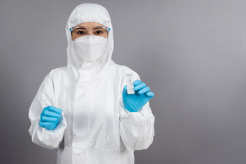doctor in PPE suit holding Coronavirus(Covid-19) negative test result with Antigen Rapid Test kit