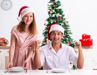 Fototapeta premium Young couple preparing for christmas meal