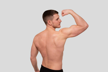 Fototapeta na wymiar Man Showing Biceps. Sportsman Showing Muscles. ABS, Biceps Muscles. Sports man Flexing Muscles. Topless Pose