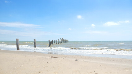 Fototapeta na wymiar Abandoned pier concrete pole in old town beside sand beach in summer season.