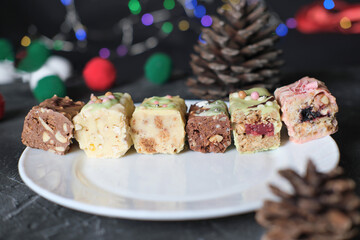  top view of protein low carb bars with various fillings cut on a plate. raw nuts and berries bars for new year celebration. diet sugar free bars decoration for holidays. keto and paleo diet