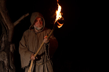 Angry farmer with torch in the middle ages