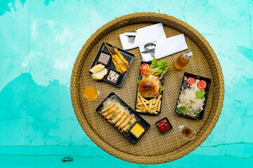Floating food in swimming pool, travel or honeymoon concept