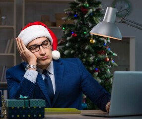 Businessman working late on christmas day in office