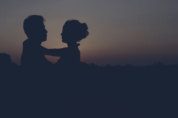 silhouette of a romantic young couple on the beach